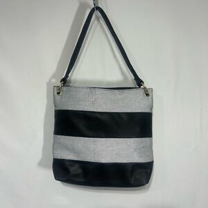 Stylish Black and white Women's Bag. Lined with packets and full zipper closure.